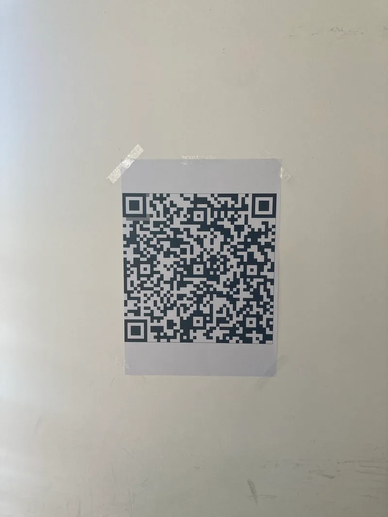 The tamper-evident QR, taped to a wall for testing